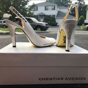 White, Studded rocker pumps with skulls engraved.